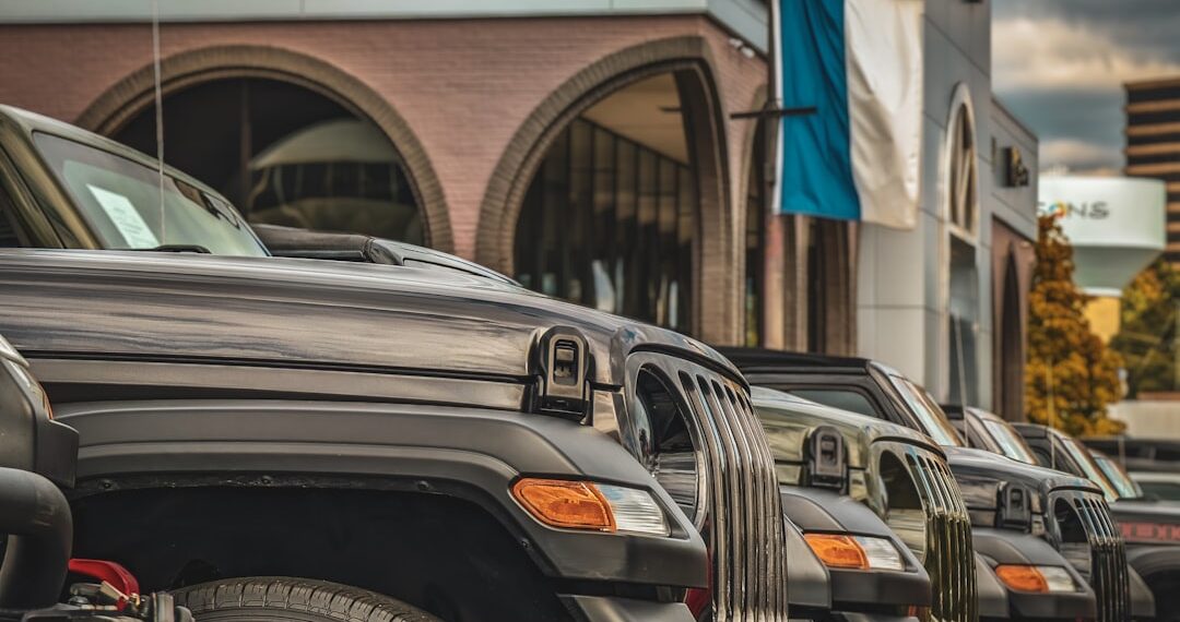 SUVs in front of a used car dealer