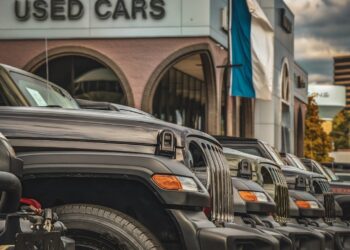 SUVs in front of a used car dealer
