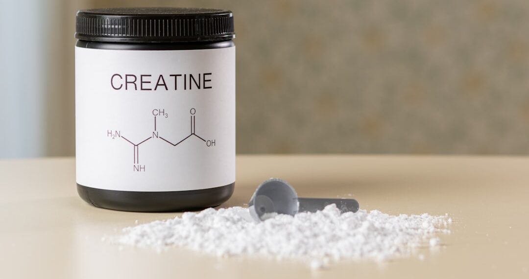 Creatine supplement jar and scoop with powder, muscle recovery and fitness