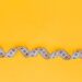 White measuring tape on a yellow background. Diet. Slimming. Obesity. Place for an inscription. Weight loss marathon. Advertising. Top view. The close plan.