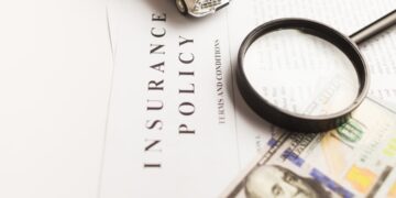 Certificate of motor insurance and policy with car and dollar bills.
